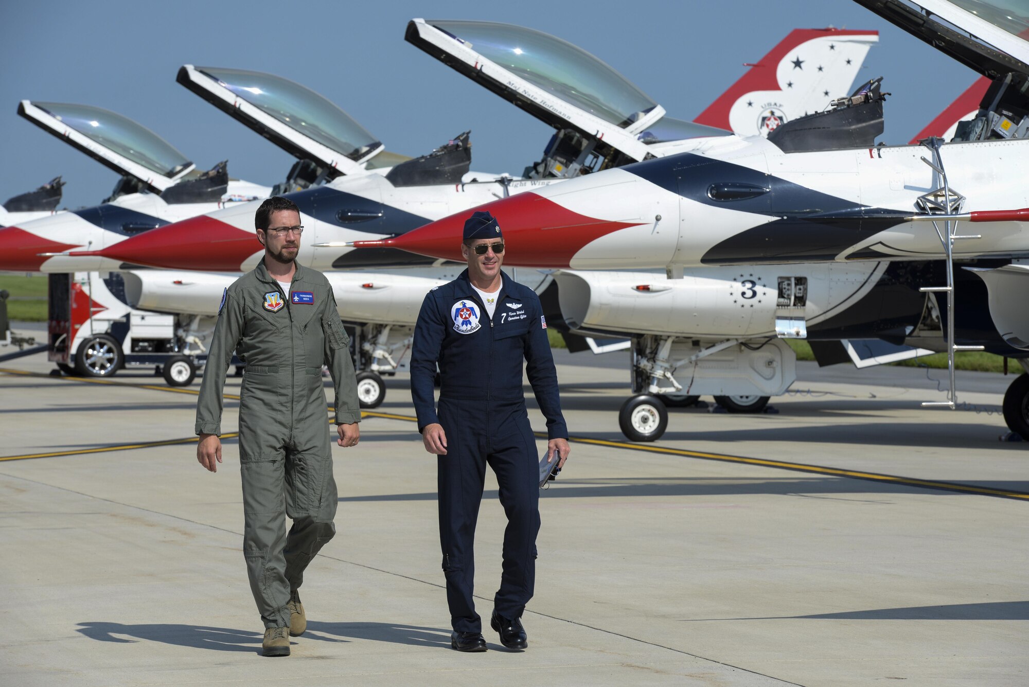 Andrew Jackson (left), radio host for 88.7 The Bridge, and Lt. Col. Kevin Walsh, U.S.A.F. Thunderbirds operations officer, walk to the No. 7 jet for a media flight Aug. 25, 2017, during the Thunder Over Dover Open House Family Day at Dover Air Force Base, Del. The Thunderbirds have performed for millions of fans since 1953, and are scheduled to complete nearly 70 performances this year. (U.S. Air Force photo by Staff Sgt. Aaron J. Jenne)