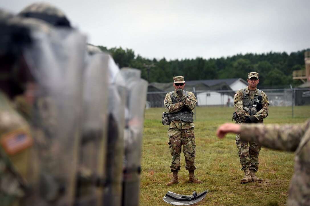 Army Reserve Chief Warrant Officer 5 Eric Nordy, left, Command Chief Warrant Officer, 85th Support Command, with 1st Sgt. Jason Hoffman, first sergeant of Headquarters and Headquarters Company, 181st Multi-functional Training Brigade, observe military police riot control training at a mock detention facility during Combat Support Training Exercise 86-17-02 at Fort McCoy, Wisconsin, from August 5 – 25, 2017.