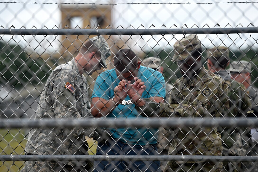 Army Reserve Military Police search a detainee at an entry control point in a mock detention facility during Combat Support Training Exercise 86-17-02 at Fort McCoy, Wisconsin, from August 5 – 25, 2017.