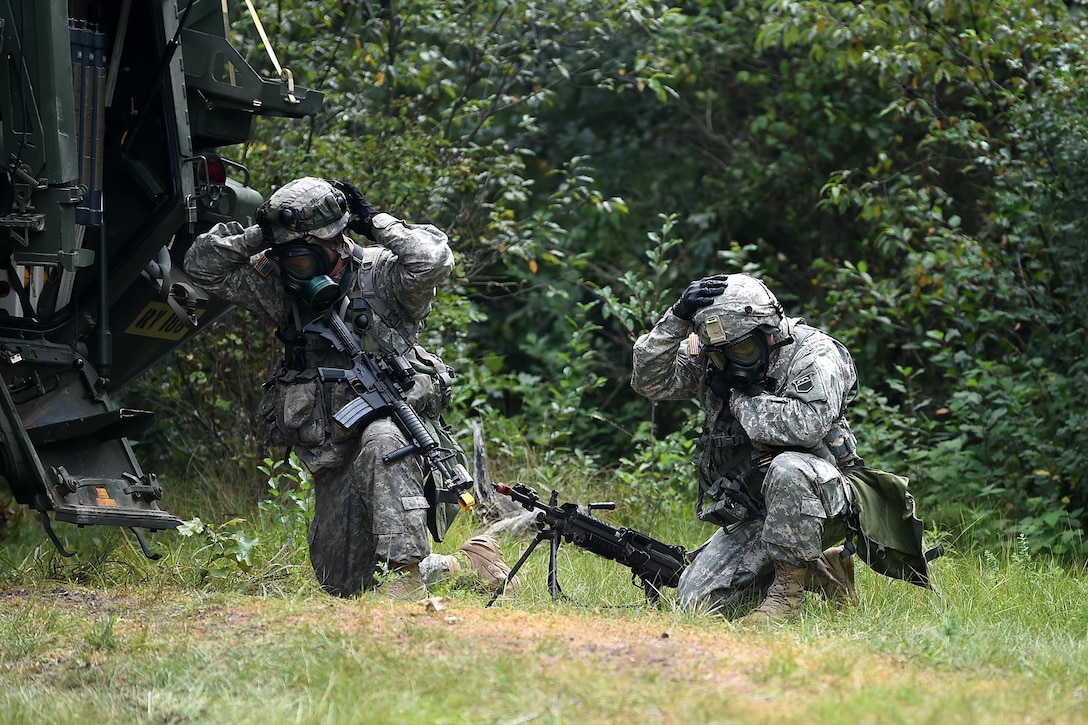 Army Reserve Soldiers don their protective mask during a simulated chemical attack outside of their perimeter at Combat Support Training Exercise 86-17-02 at Fort McCoy, Wisconsin, from August 5 – 25, 2017.
