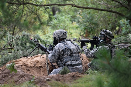 Army Reserve Soldiers move into their fighting positions during a simulated artillery and chemical attack outside of their perimeter at Combat Support Training Exercise 86-17-02 at Fort McCoy, Wisconsin, from August 5 – 25, 2017.