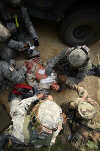 Army Reserve Soldiers assigned to the 693rd Quartermaster Company, Bell, California, treat a casualty after an ambush during Combat Support Training Exercise 86-17-02 at Fort McCoy, Wisconsin, from August 5 – 25, 2017.