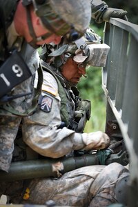 Army Reserve Staff Sgt. Byron Molina, assigned to the 693rd Quartermaster Company, Bell, California, secures a pin from a tow bar to a disabled humvee following an attack during Combat Support Training Exercise 86-17-02 at Fort McCoy, Wisconsin, from August 5 – 25, 2017.