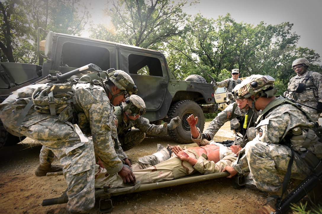 Army Reserve Soldiers, assigned to the 693rd Quartermaster Company, Bell, California, prepare to conduct a litter evacuation following an attack during Combat Support Training Exercise 86-17-02 at Fort McCoy, Wisconsin, from August 5 – 25, 2017.