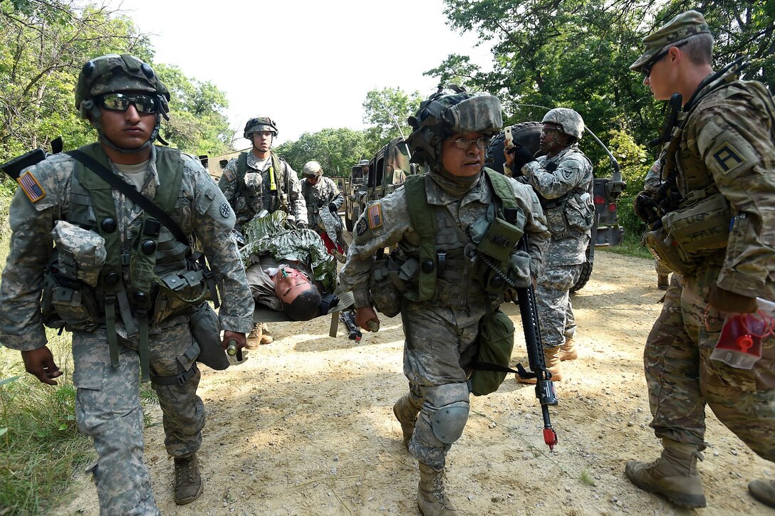 Army Reserve Soldiers, assigned to the 693rd Quartermaster Company, Bell, California, evacuate a casualty after an attack on their convoy during Combat Support Training Exercise 86-17-02 at Fort McCoy, Wisconsin, from August 5 – 25, 2017.