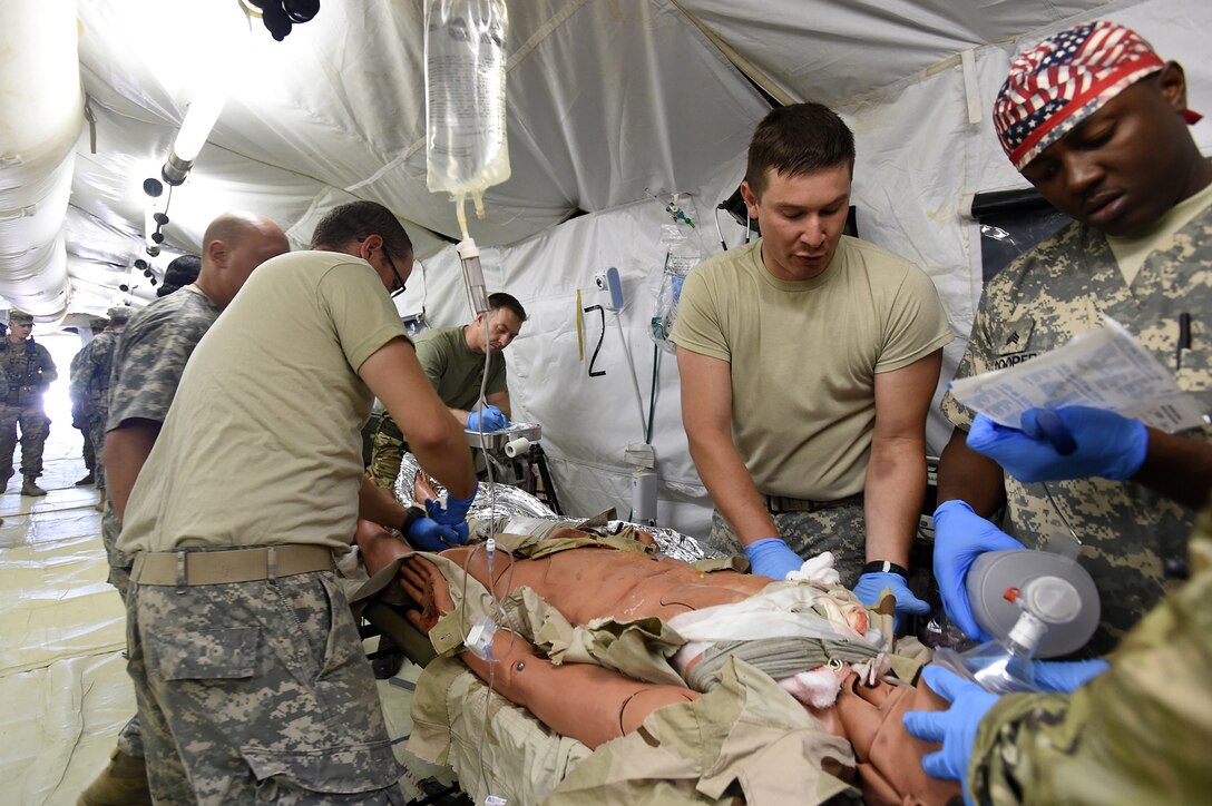 Army Reserve Soldiers, assigned to the 256th Combat Support Hospital, Twinsburg, Ohio, triage a mock trauma patient ambushed in an attack during Combat Support Training Exercise 86-17-02 at Fort McCoy, Wisconsin, from August 5 – 25, 2017.