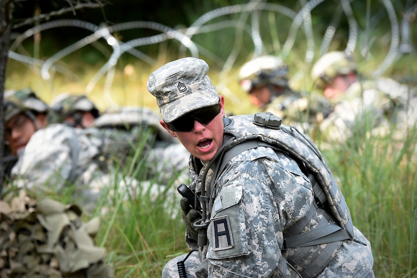 Army Reserve Sgt. 1st Class Miranda Herrmann, observer coach/trainer from the 2nd Battalion, 361st Training Support Regiment, 181st Multi-functional Training Brigade, yells out to Soldiers, from her training unit, during a base attack at Combat Support Training Exercise 86-17-02 at Fort McCoy, Wisconsin, from August 5 – 25, 2017.