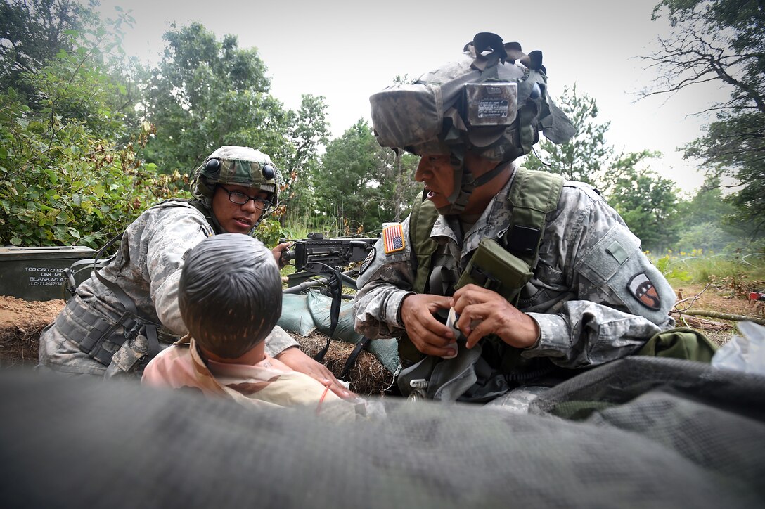 Army Reserve Soldiers, assigned to the 693rd Quartermaster Company, Bell, California, treat a casualty during a base attack at Combat Support Training Exercise 86-17-02 at Fort McCoy, Wisconsin, from August 5 – 25, 2017.