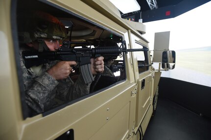 Army Reserve Spc. Andrew Bahun, from the 454th Transportation Company, Columbus, Ohio, engages targets during a high value target extraction in a Reconfigurable Vehicle Tactical Trainer 360-degree immersion simulator at Combat Support Training Exercise 86-17-02 at Fort McCoy, Wisconsin, from August 5 – 25, 2017.