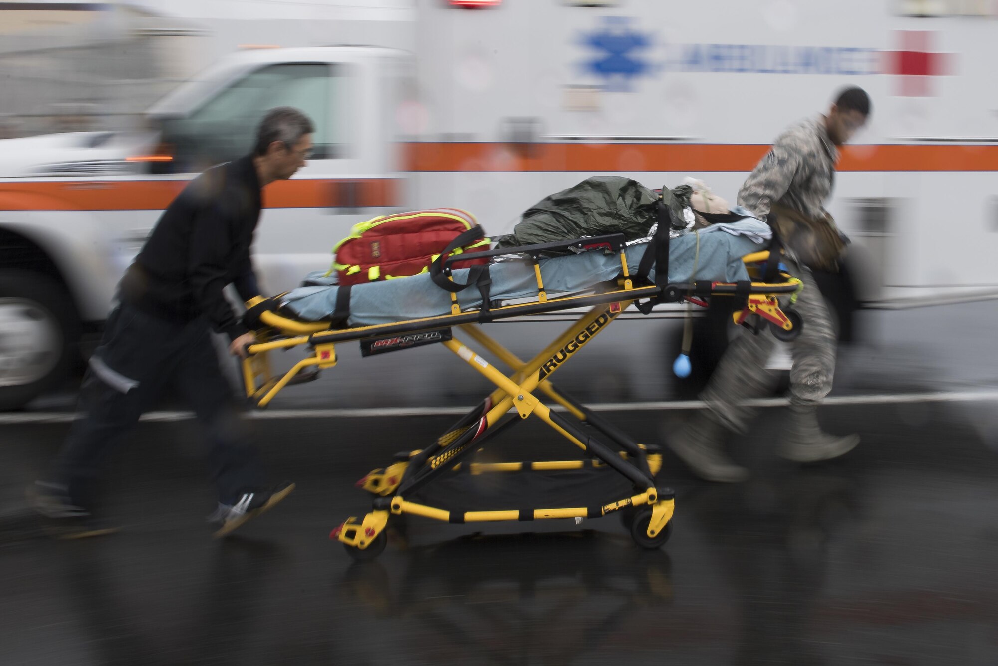 Emergency responders from the 374th Medical Group transport a simulated victim during an active shooter exercise, Aug. 16, 2017, at Yokota Air Base, Japan. The top priority after an active shooter event is tending to victims to prevent further loss of life. (U.S. Air Force photo by Airman 1st Class Donald Hudson)