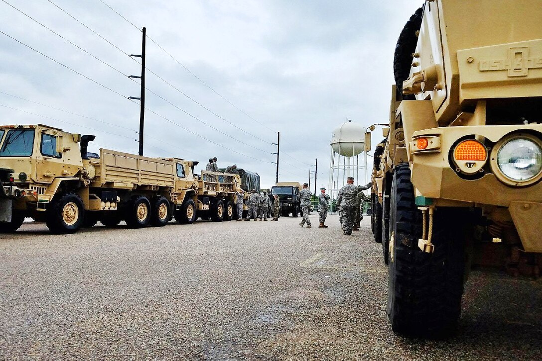A group of Guardsmen prepare vehicles in Austin.