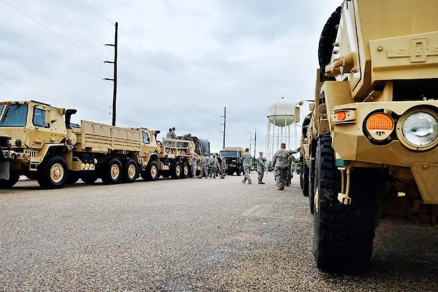 A group of Guardsmen prepare vehicles in Austin.