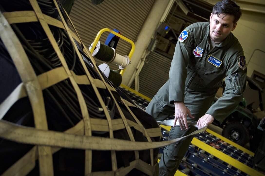 Air Force Staff Sgt. Todd Johnson secures a pallet of equipment in preparation for rescue operations following Hurricane Harvey