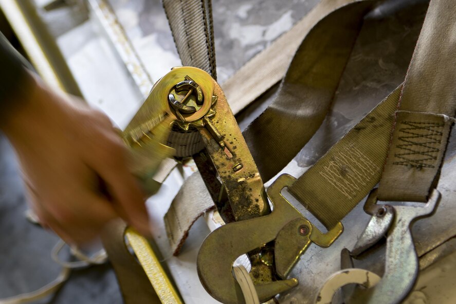 U.S. Air Force Staff Sgt. Todd Johnson, 347th Operations Support Squadron weapons and tactics loadmaster, tightens a pallet of equipment in preparation for rescue operations following Hurricane Harvey, Aug. 25, 2017, at Moody Air Force Base, Ga.