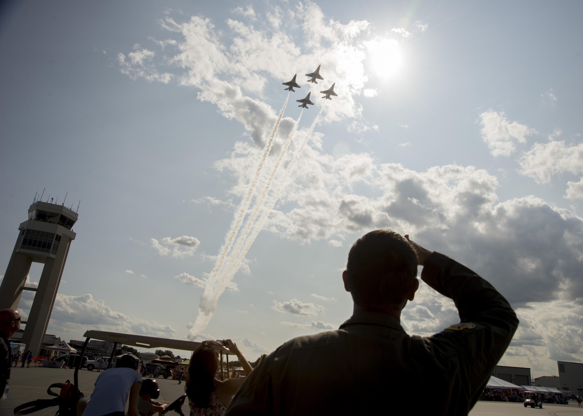 Col. Ethan Griffin, 436th Airlift Wing commander, watches as the Thunderbirds soar overhead Aug. 26, 2017, during the Thunder Over Dover Open House at Dover Air Force Base, Del. The Thunderbirds have performed for millions of fans since 1953, and are scheduled to complete nearly 70 performances this year. (U.S. Air Force photo by Staff Sgt. Jared Duhon)