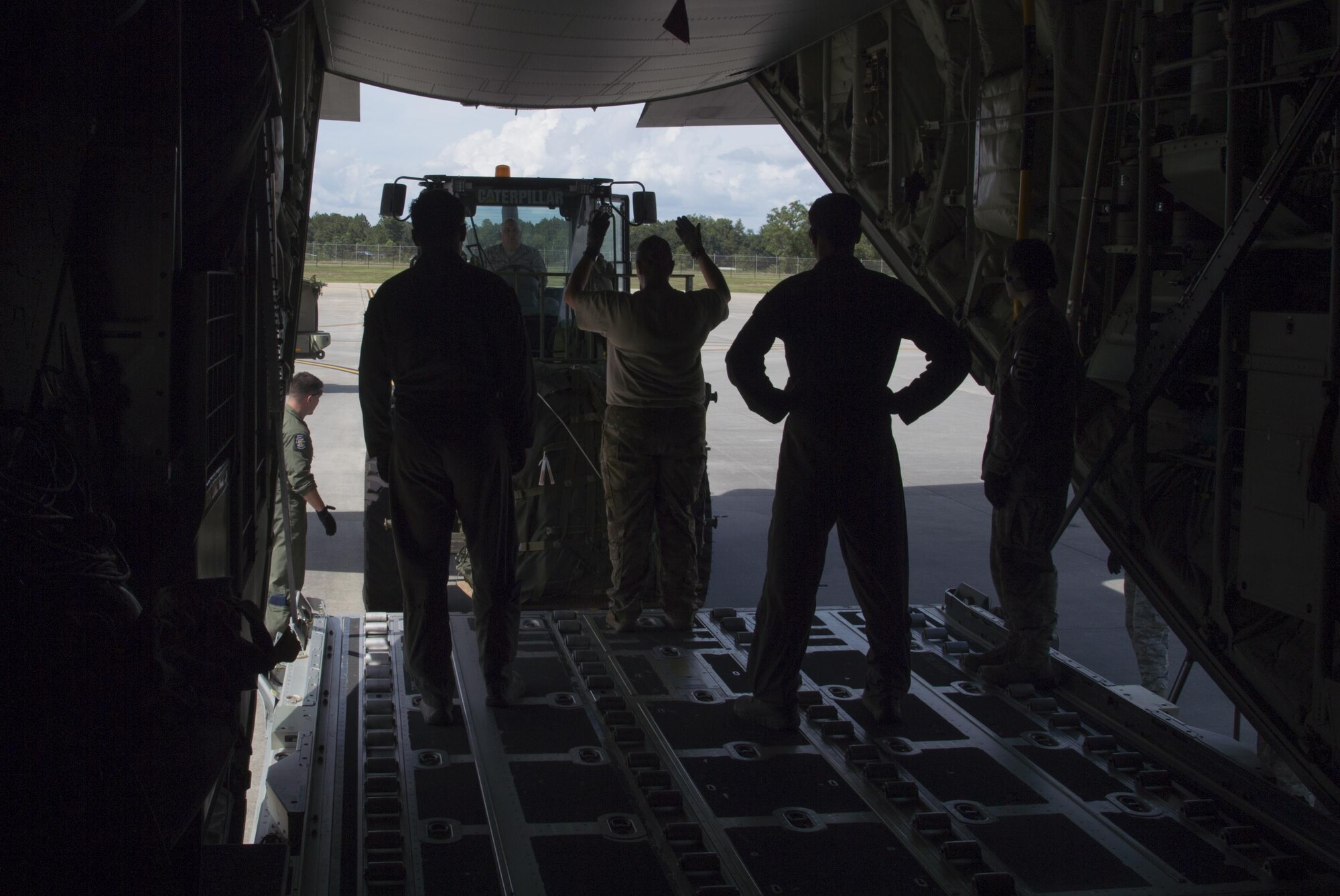 U.S. Air Force members from the 71st Rescue Squadron guide a forklift holding gear and equipment onto an HC-130J Combat King II traveling to Texas in preparation of possible hurricane relief support August 26, 2017, at Moody Air Force Base, Ga.