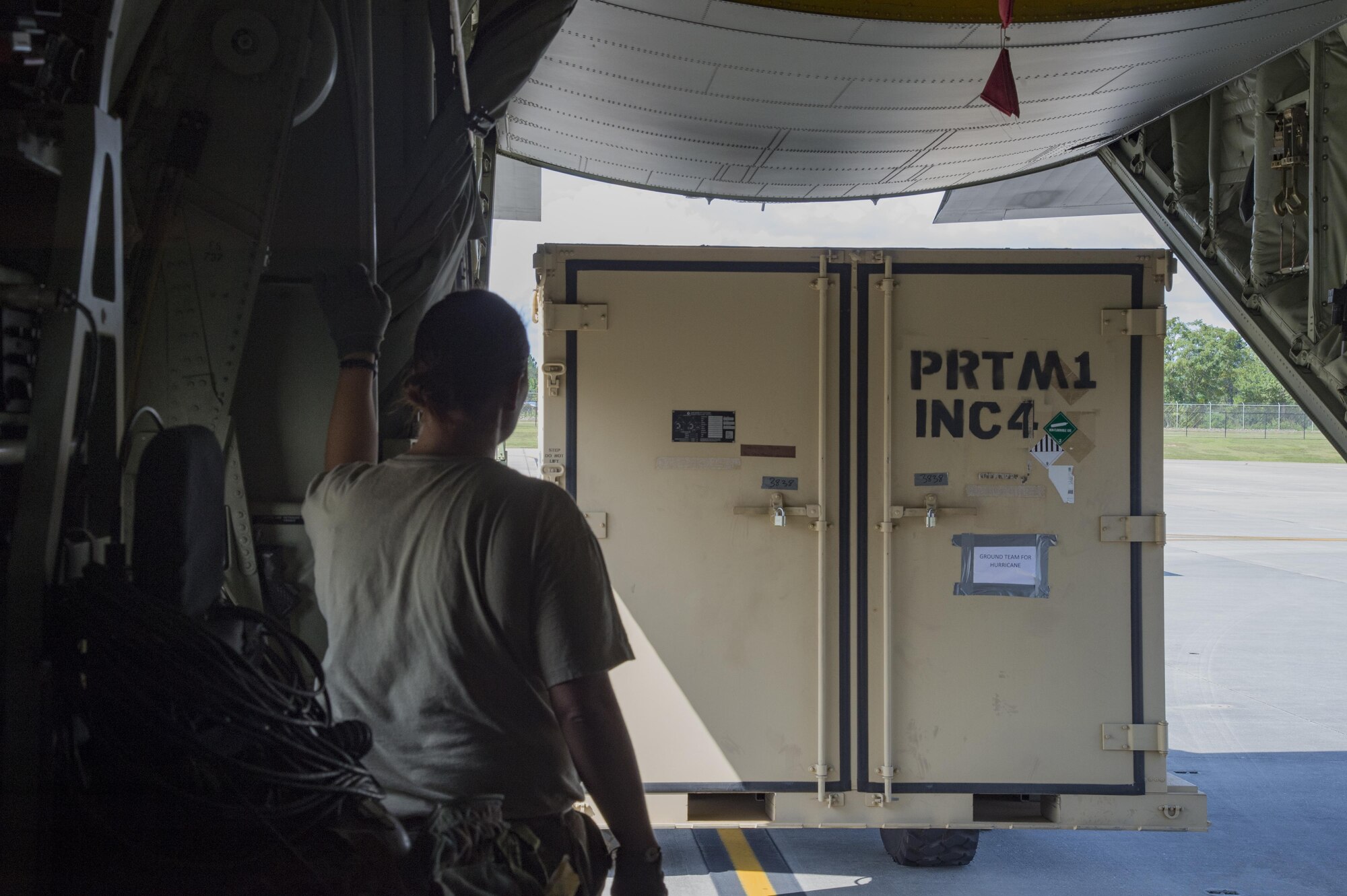 A U.S. Air Force member from the 71st Rescue Squadron guides a forklift carrying a container of equipment in to a HC-130J Combat King II traveling to Texas in preparation for possible hurricane relief support August 26, 2017, at Moody Air Force Base, Ga.
