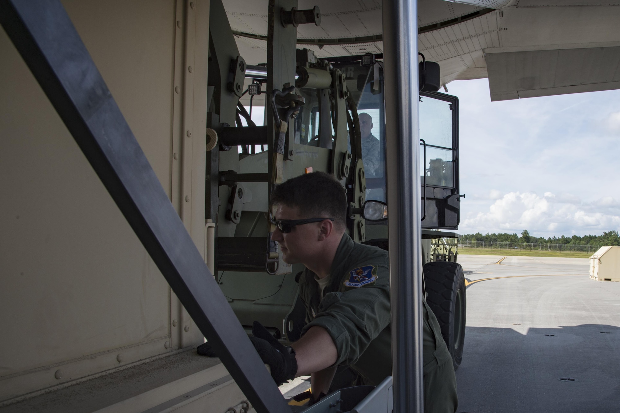An U.S. Air Force member from the 71st Rescue Squadron guides a forklift carrying a container of equipment in to a HC-130J Combat King II traveling to Texas in preparation of possible hurricane relief support August 26, 2017, at Moody Air Force Base, Ga.