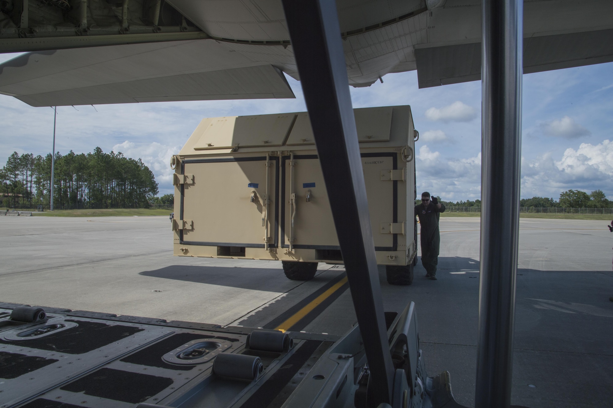 An U.S. Air Force member from the 71st Rescue Squadron guides a forklift carrying a container of equipment in to a HC-130J Combat King II traveling to Texas in preparation of possible hurricane relief support August 26, 2017, at Moody Air Force Base, Ga.