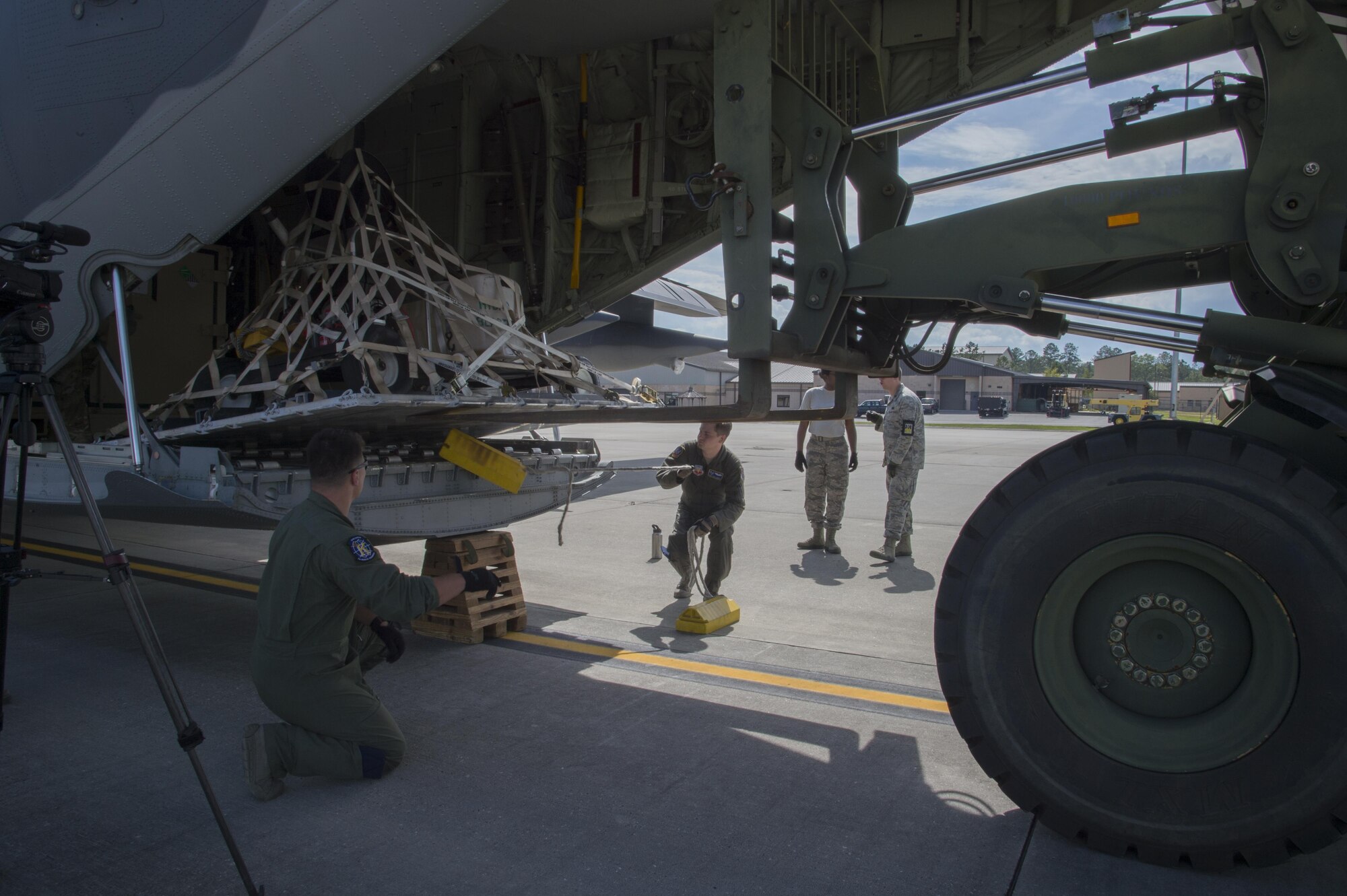 Two U.S. Air Force load masters from the 71st Rescue Squadron remove chalks from a pallet as it is placed in to a HC-130J Combat King II traveling to Texas in preparation of possible hurricane relief support August 26, 2017, at Moody Air Force Base, Ga.