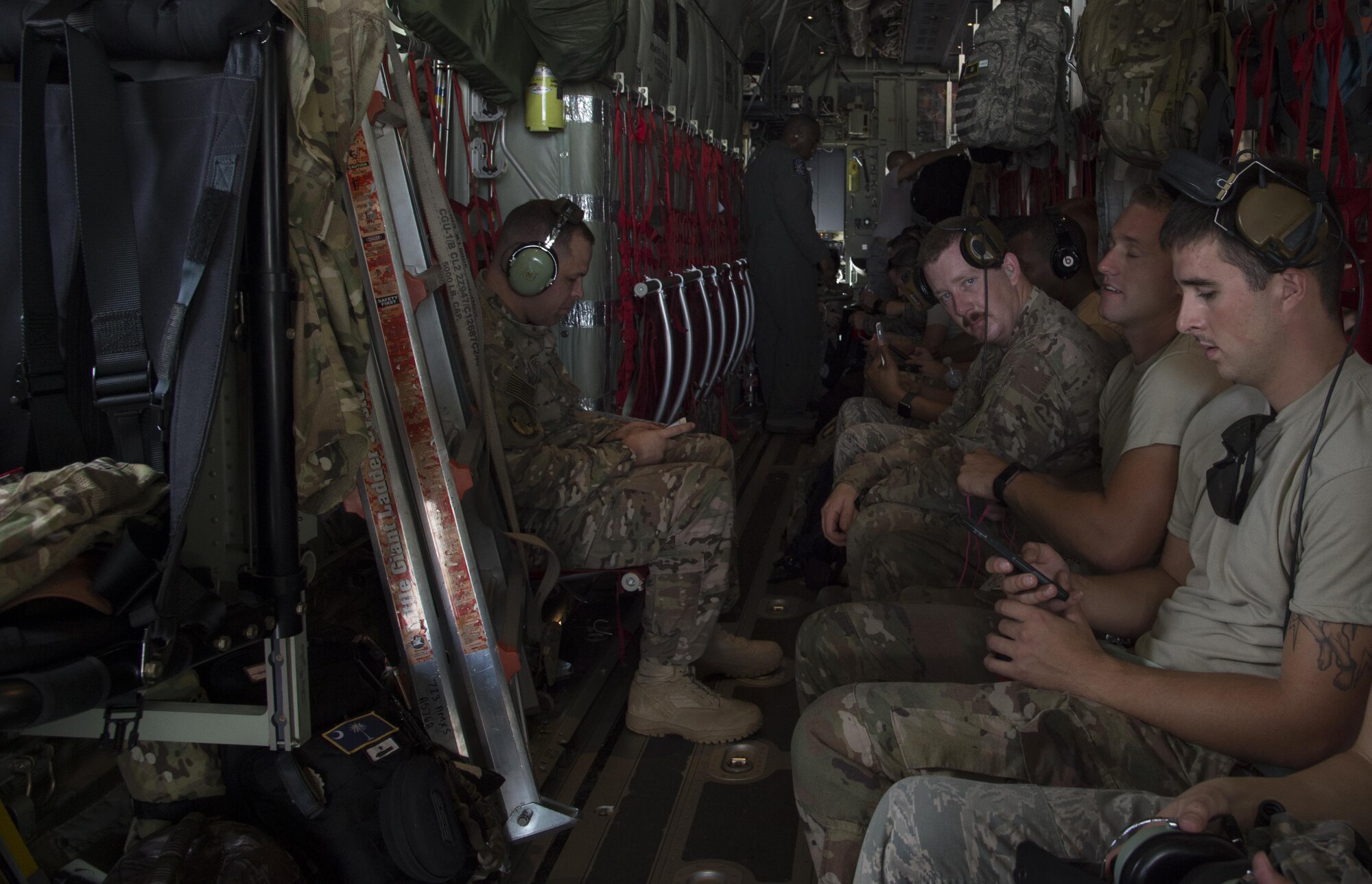 U.S. Air Force members from the 71st and 41st Rescue squadrons sit on a HC-130J Combat King II traveling to Texas in preparation of possible hurricane relief support August 26, 2017, at Moody Air Force Base, Ga.