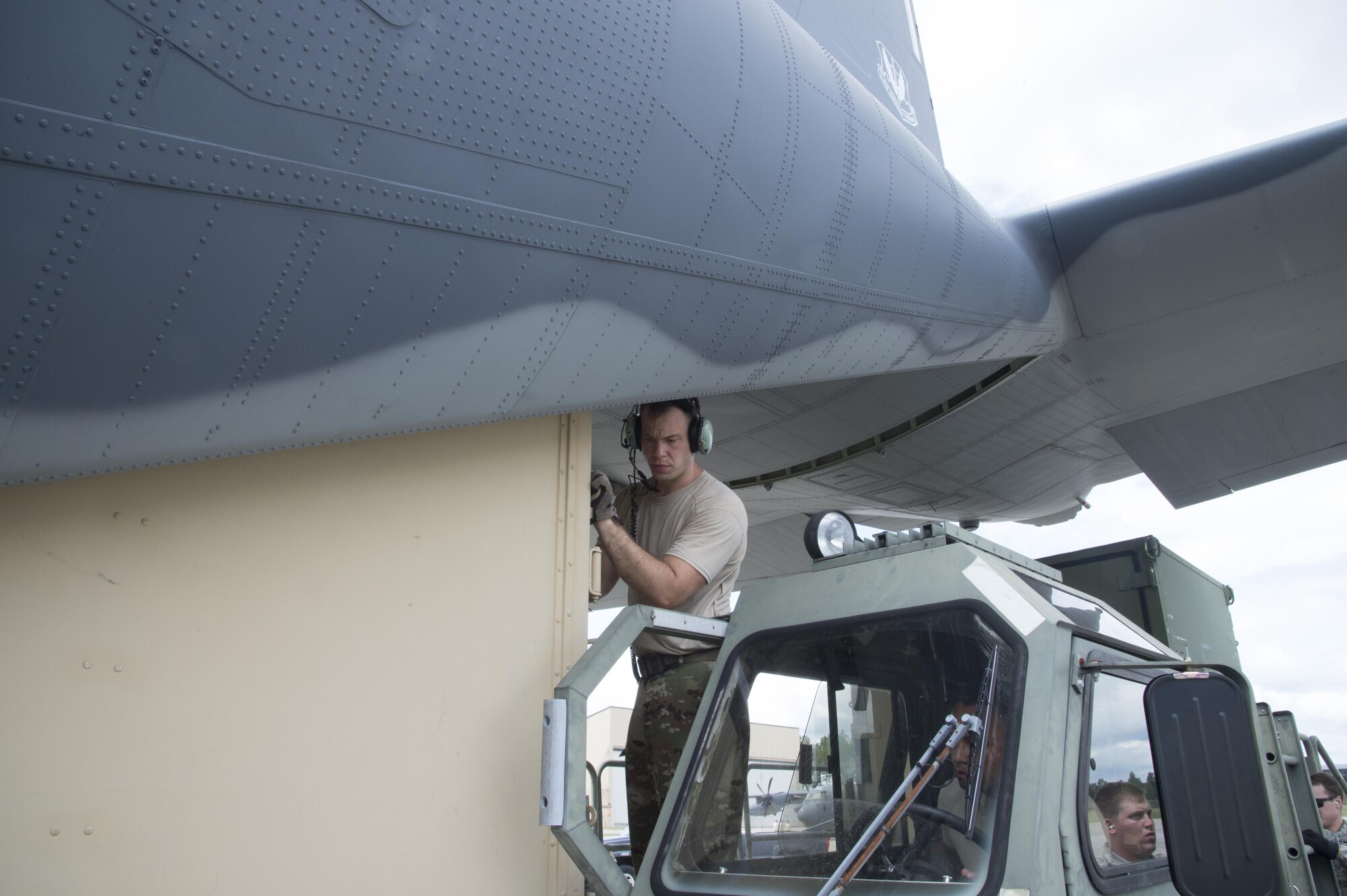 A U.S. Air Force crew chief from the 71st Rescue Squadron pushes a container on to a HC-130J Combat King II traveling to Texas in preparation of possible hurricane relief support August 26, 2017, at Moody Air Force Base, Ga.