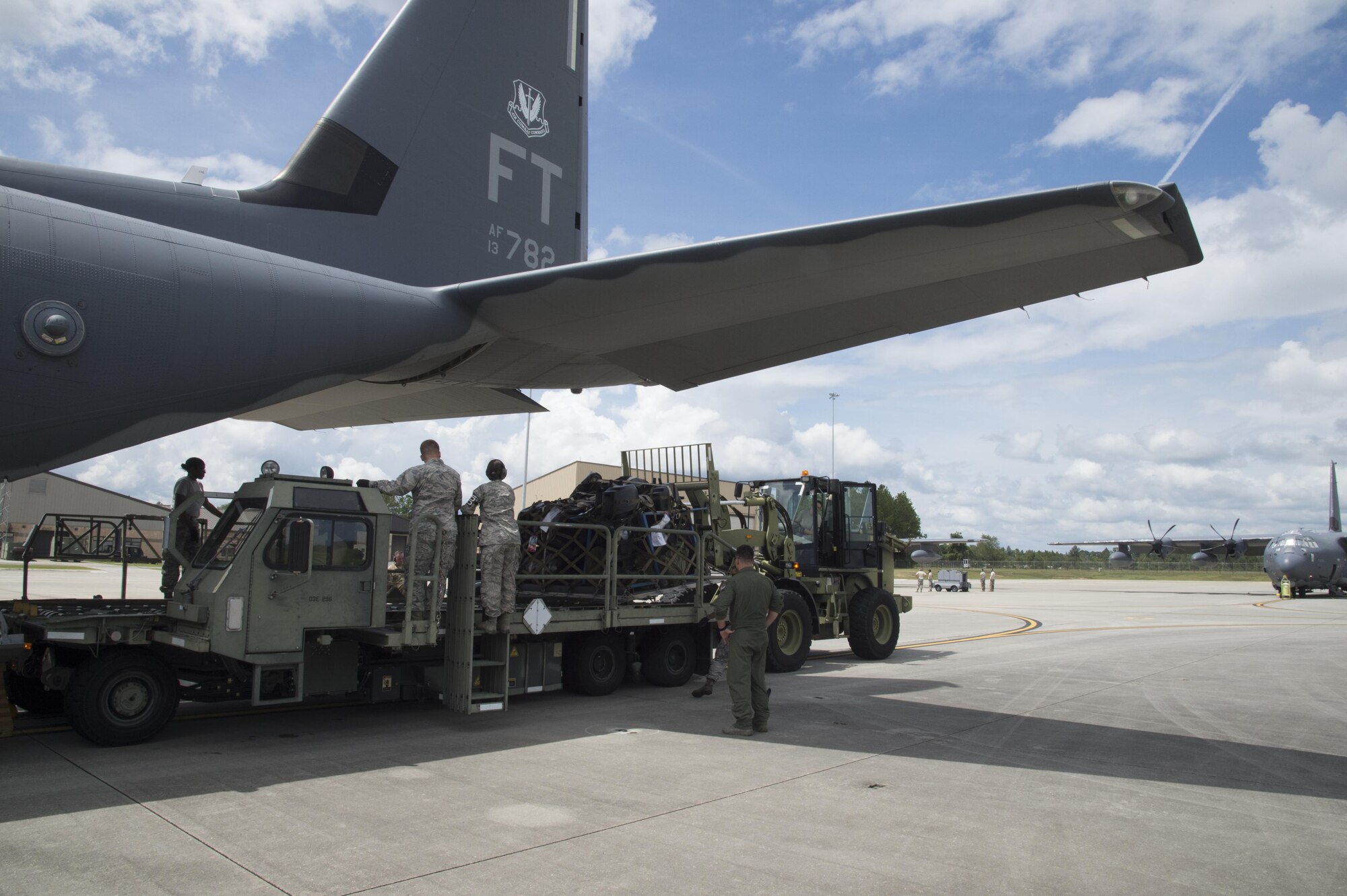 U.S. Air Force members from the 23d Wing direct cargo to be loaded on to a HC-130J Combat King II traveling to Texas in preparation of possible hurricane relief support August 26, 2017, at Moody Air Force Base, Ga.