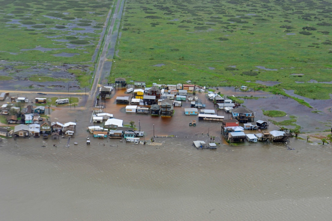 An aerial view of homes and buildings surrounded by water in Texas.