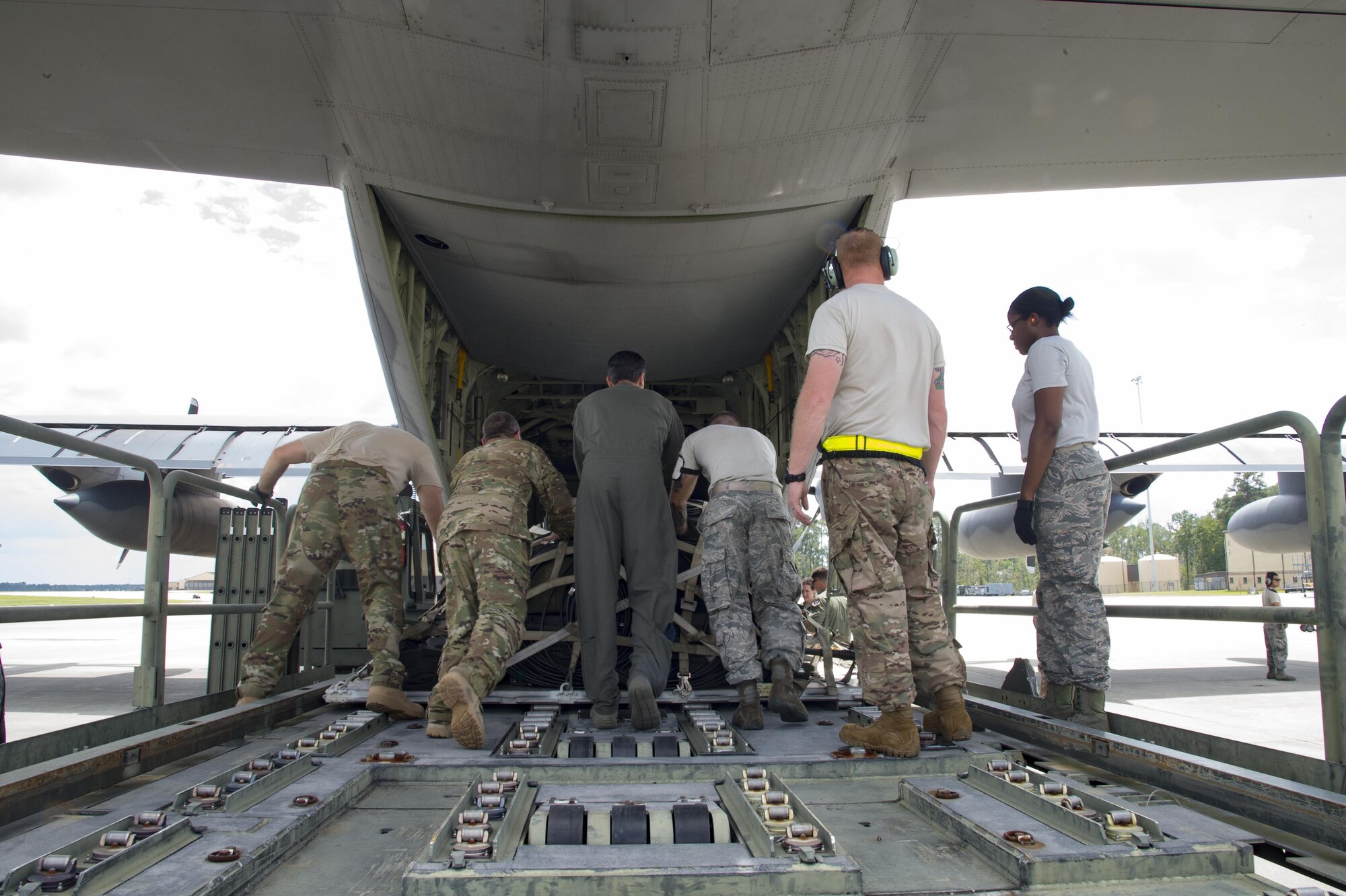 U.S. Air Force members from the 71st Rescue Squadron push a storage container on to a HC-130J Combat King II traveling to Texas in preparation of possible hurricane relief support August 26, 2017, at Moody Air Force Base, Ga.