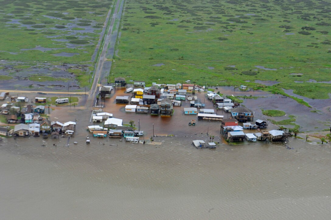 An aerial view of homes and buildings surrounded by water in Texas.