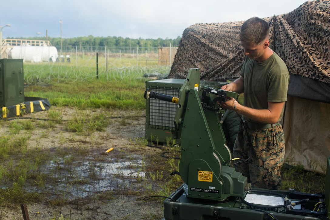 U.S. Marine Corps Cpl. Chance A. Feller, a radio operator with Combat Logistics Battalion 26, 26th Marine Expeditionary Unit (MEU), attaches wires to a Very Small Aperture Terminal Small (VSAT-S) during Realistic Urban Training (RUT) at Marine Corps Outlying Field Camp Davis-South, N.C., Aug. 16, 2017. RUT allows the 26th MEU Marines to gain operational experience working as a unit in an urban environment as preparation for an upcoming deployment at sea. (U.S. Marine Corps photo by Lance Cpl. Jered T. Stone)