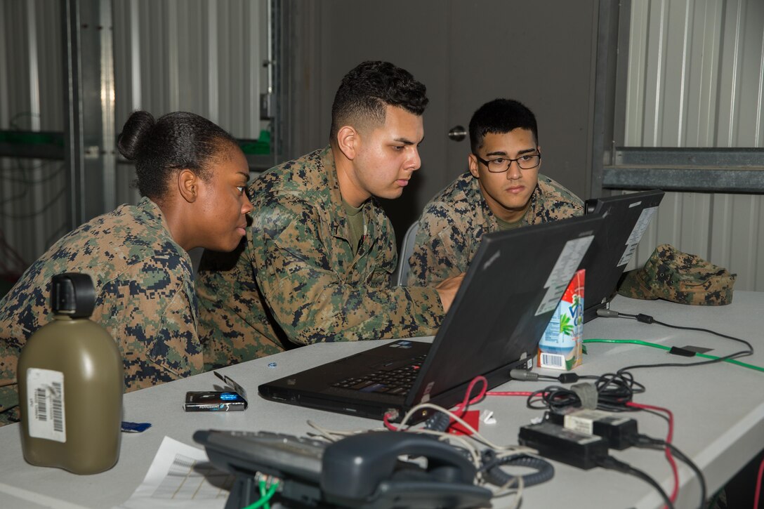 U.S. Marine Corps Pfc. Chrisandra R. BrownYoung, left, Lance Cpl. Adam I. Balladro, center, and Lance Cpl. Alec L. Ruiz, all administrative specialists with the 26th Marine Expeditionary Unit (MEU), work on a personnel accountability roster during Realistic Urban Training (RUT) at Marine Corps Outlying Field Camp Davis-South, N.C., Aug. 16, 2017.