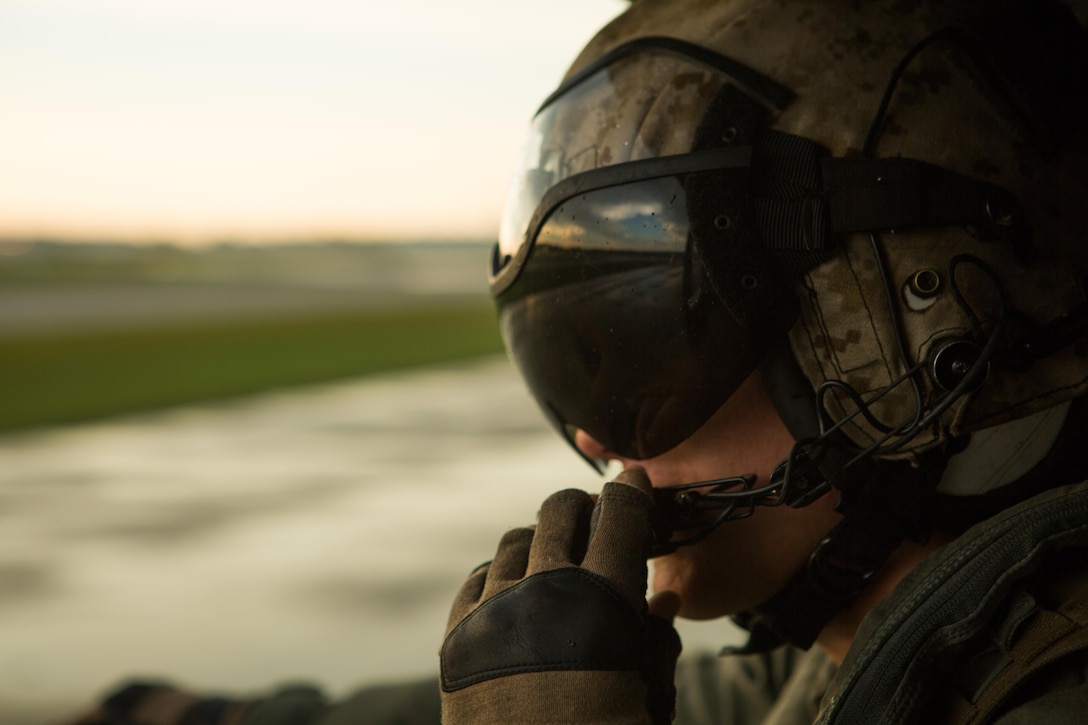 U.S. Marine Corps Sgt. Kyle J. Mohr, a crew chief with Marine Medium Tiltrotor Squadron (VMM) 162 (Reinforced), 26th Marine Expeditionary Unit (MEU), observes the flight-line during takeoff above Marine Corps Air Station New River, N.C., Aug. 19, 2017.