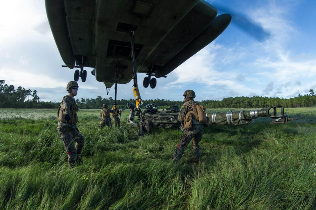 U.S. Marines with Combat Logistics Battalion 26, 26th Marine Expeditionary Unit (MEU), attach an M777 Howitzer 155mm to a CH-53E Super Stallion with Marine Medium Tiltrotor Squadron (VMM) 162 (Reinforced), 26th MEU, during Helicopter Support Team training on Camp Lejeune, N.C., Aug. 22, 2017. Marines conducted the training to support operations during Realistic Urban Training, and prepare for an upcoming deployment at sea. (U.S. Marine Corps photo by Lance Cpl. Jered T. Stone)