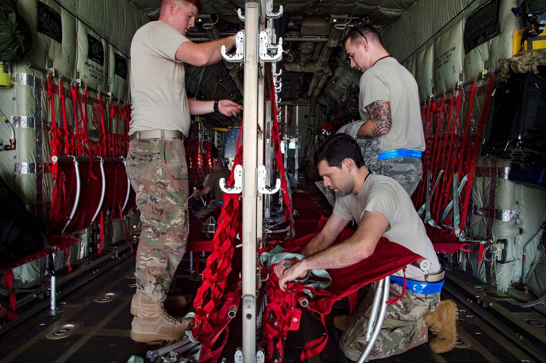 Airmen assemble seats on an HC-130J Combat King II aircraft in preparation of Hurricane Harvey relief.