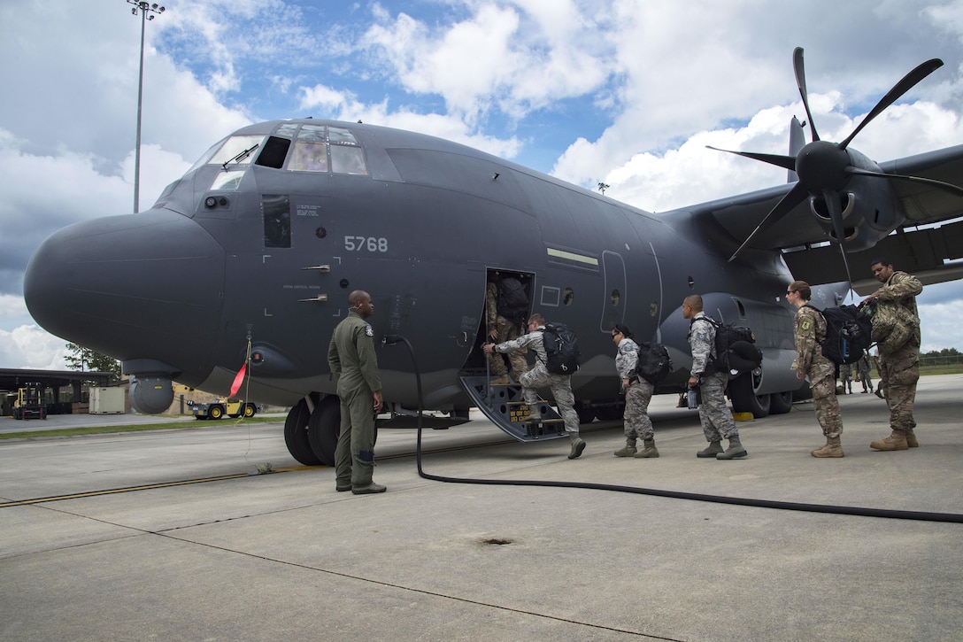 Airmen board an HC-130J Combat King II aircraft that was traveling to Texas for Hurricane Harvey relief.
