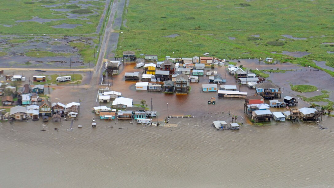 An aerial view of homes and buildings surrounded by water in Texas.