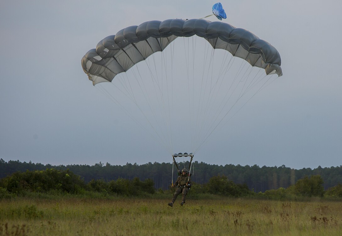 A U.S. Marine with the Maritime Raid Force (MRF), 26th Marine Expeditionary Unit (MEU), prepares to land during airborne sustainment training at Camp Lejeune, N.C., Aug.15, 2017.