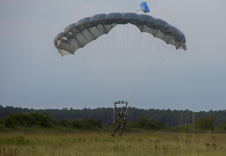 A U.S. Marine with the Maritime Raid Force (MRF), 26th Marine Expeditionary Unit (MEU), prepares to land during airborne sustainment training at Camp Lejeune, N.C., Aug.15, 2017.