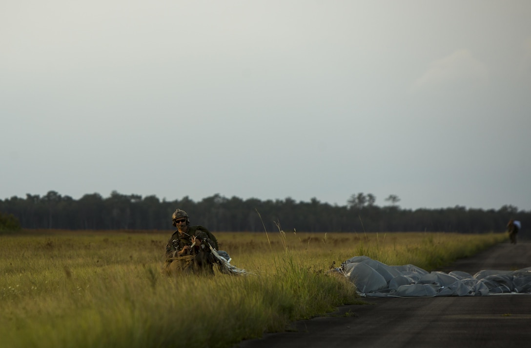A U.S. Marine with the Maritime Raid Force (MRF), 26th Marine Expeditionary Unit (MEU), carries a Multi-Mission Parachute System during static line jump training at Camp Lejeune, N.C., Aug.15, 2017.