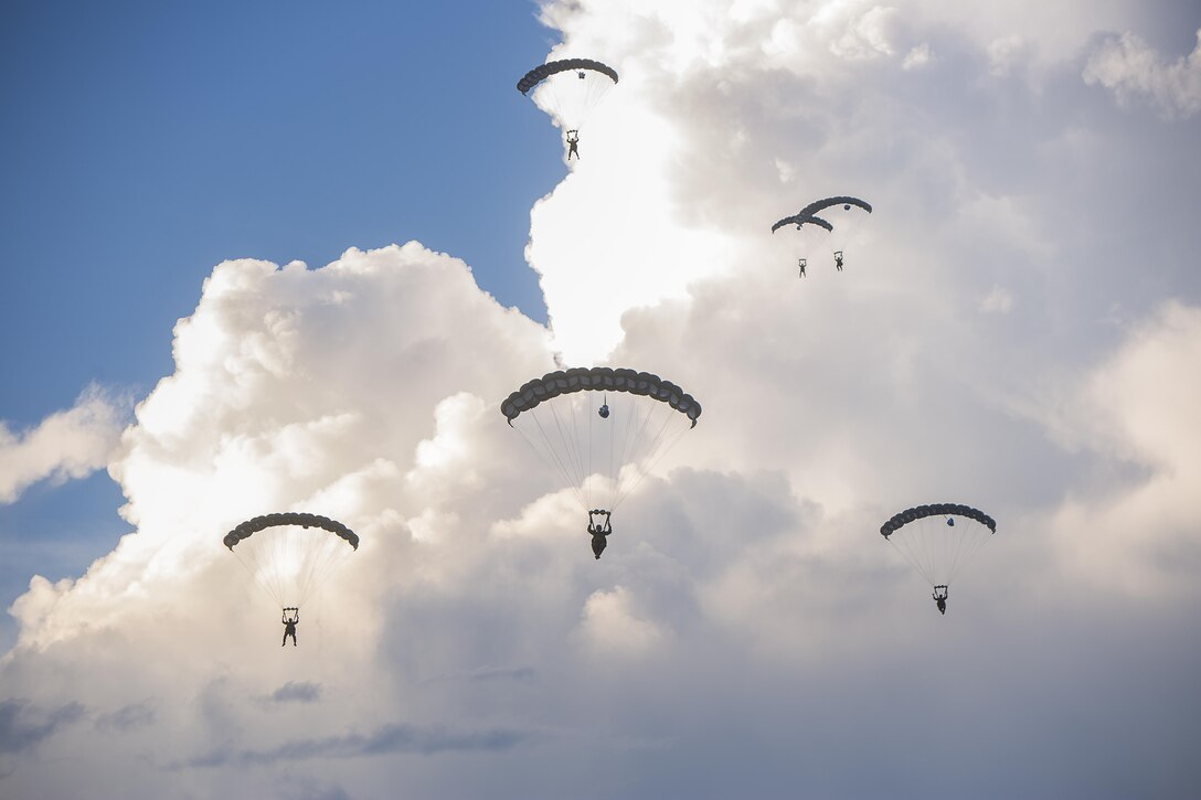 U.S. Marines with the Maritime Raid Force (MRF), 26th Marine Expeditionary Unit (MEU), execute a static line jump from an MV-22B Osprey aircraft with Marine Medium Tiltrotor Squadron 162 (Reinforced) and parachute to the ground during sustainment jump training at Camp Lejeune, N.C., Aug.15, 2017.