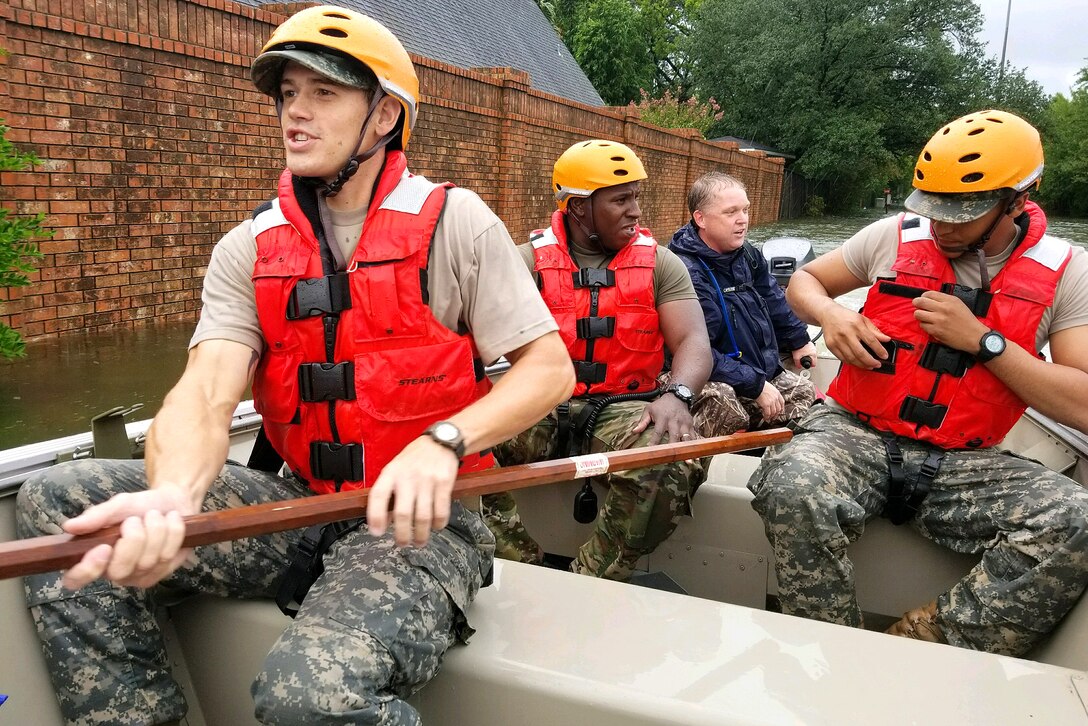 Texas National Guardsmen assist residents affected by flooding caused by Hurricane Harvey in Houston.