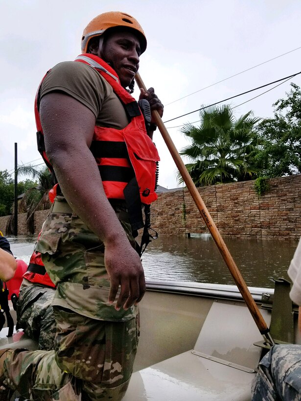 Texas National Guardsmen ride in a boat as they seek to help residents affected by Hurricane Harvey flooding.