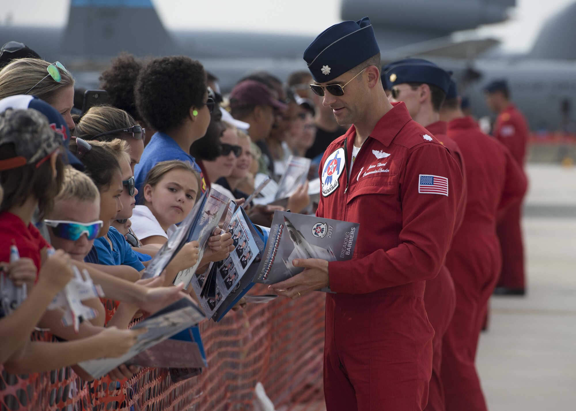 Lt. Col. Jason Heard, commander/leader of the U.S. Air Force Thunderbirds Air Demonstration Squadron and pilot of the No. 1 jet signs autographs after completing a performance during the Thunder Over Dover Open House Aug. 27, 2017, at Dover Air Force Base, Del. The Thunderbirds demonstrated the versatility of the F-16 Fighting Falcon by performing aerial acrobatics, precision formations and high-speed passes during their performance. (U.S. Air Force photo by Senior Airman Zachary Cacicia)