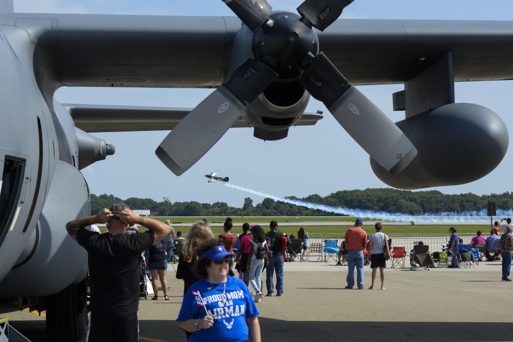 Spectators watch as an aerial performer flies by Aug. 27, 2017, during the Thunder Over Dover Open House at Dover Air Force Base, Del. The open house was a free, two-day event that featured more than 20 aerial demonstrations, static aircraft displays and other events. (U.S. Air Force photo by Staff Sgt. Aaron J. Jenne)