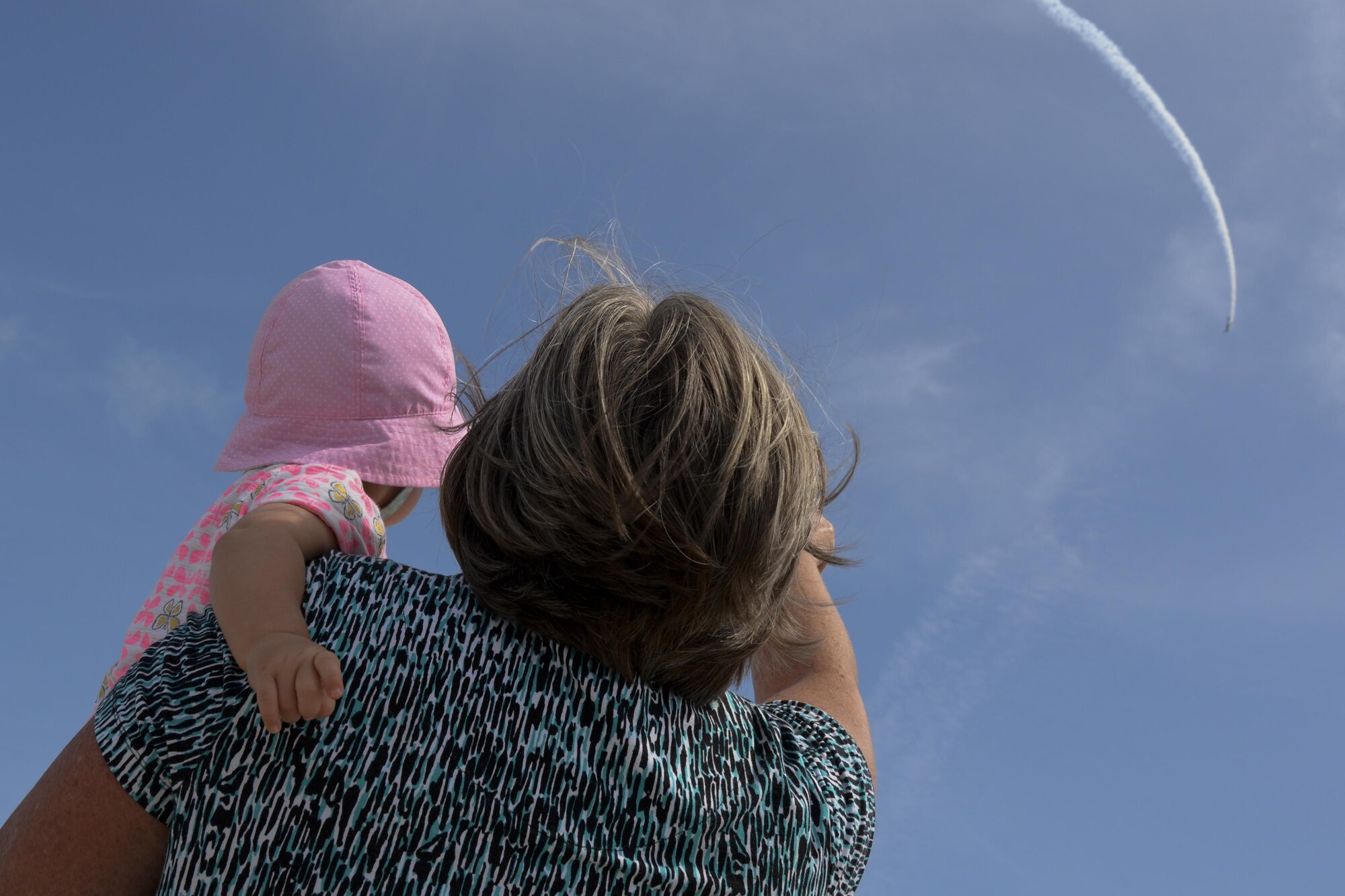 Guests of Team Dover watch an aerial performer fly above Dover Air Force Base, Del., Aug. 27, 2017, during the Thunder Over Dover Open House. This was Team Dover’s first open house since 2009, and the first held on the base since 1994. (U.S. Air Force photo by Staff Sgt. Aaron J. Jenne)