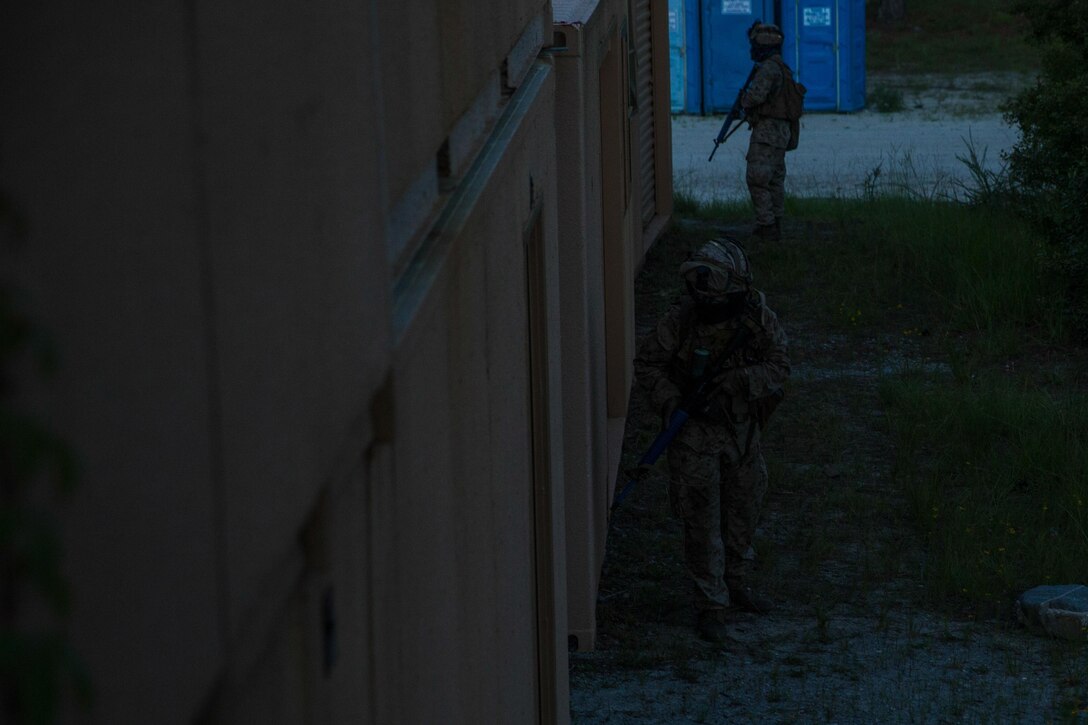 U.S. Marines with Battalion Landing Team 2nd Battalion, 6th Marine Regiment, 26th Marine Expeditionary Unit (MEU), provide security during a battalion force-on-force exercise for Military Operations in Urban Terrain as part of Realistic Urban Training (RUT) at Camp Lejeune, N.C., Aug. 16, 2017.