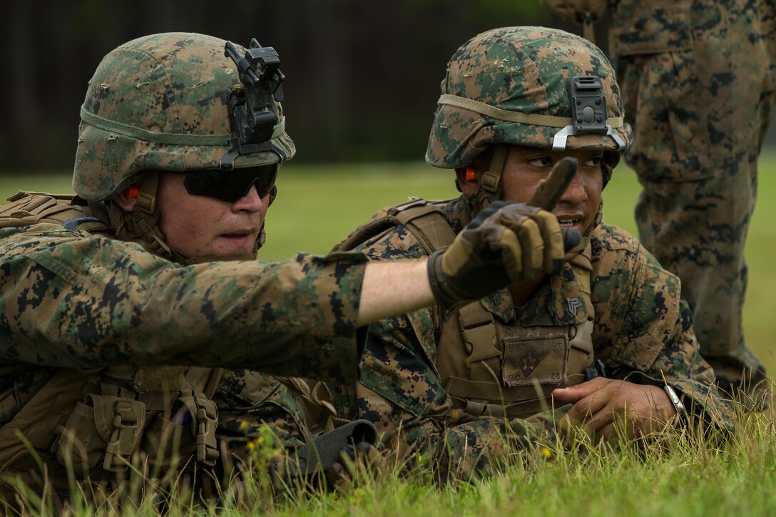 U.S. Marine Corps Lance Cpl. Roger L. Booker Jr., left, a mortarman with Battalion Landing Team 2nd Battalion, 6th Marine Regiment, 26th Marine Expeditionary Unit (MEU), and Sgt. Brandon M. Park, a section leader, observe a target area during a mortar firing range as part of Realistic Urban Training (RUT) at Camp Lejeune, N.C., Aug. 21, 2017.