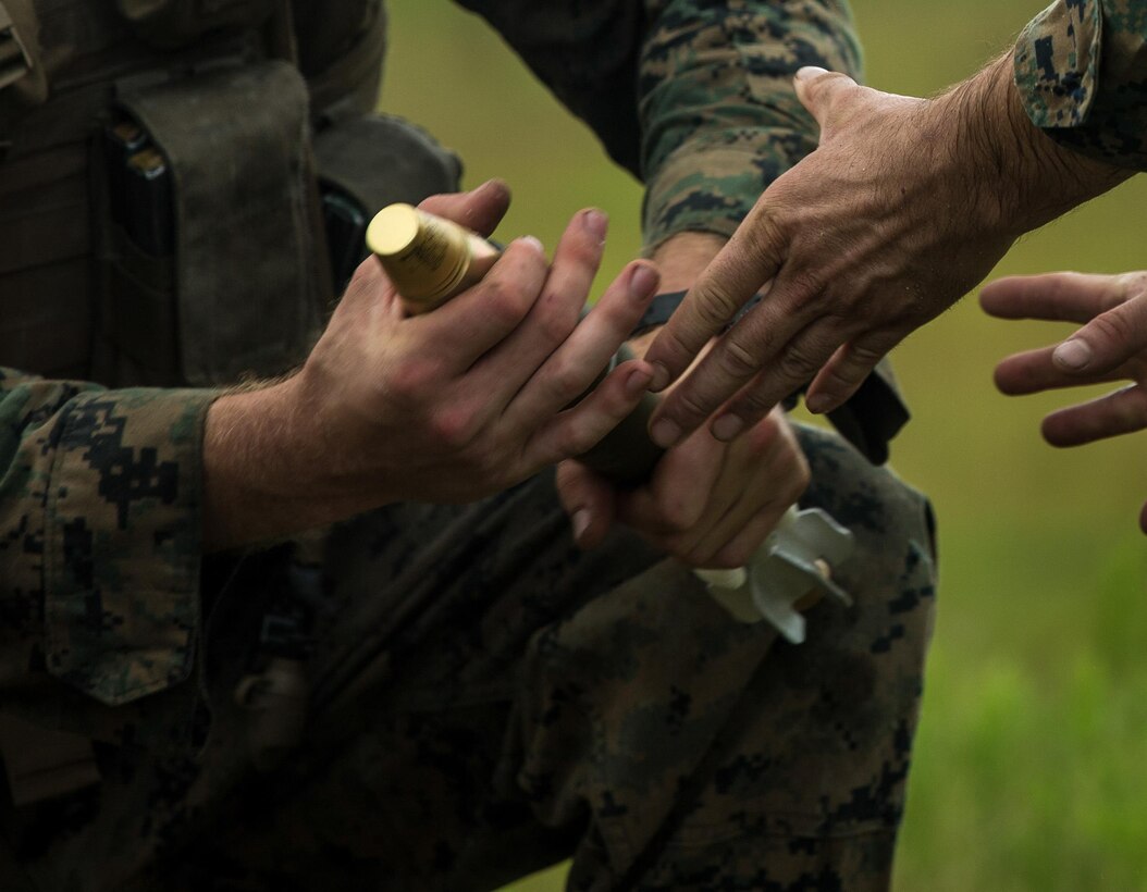 U.S. Marines with Battalion Landing Team 2nd Battalion, 6th Marine Regiment, 26th Marine Expeditionary Unit (MEU), handle a 60mm mortar during a mortar firing range as part of Realistic Urban Training (RUT) at Camp Lejeune, N.C., Aug. 21, 2017.