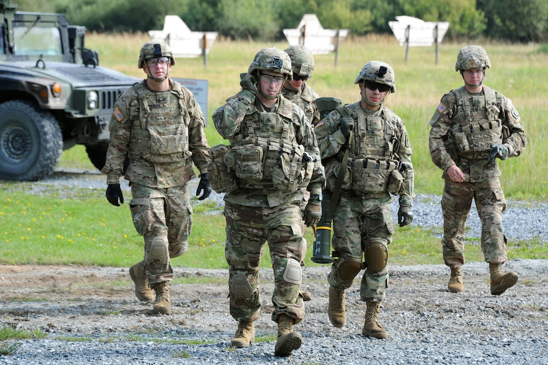 Soldiers walk to the firing line during weapons familiarization training